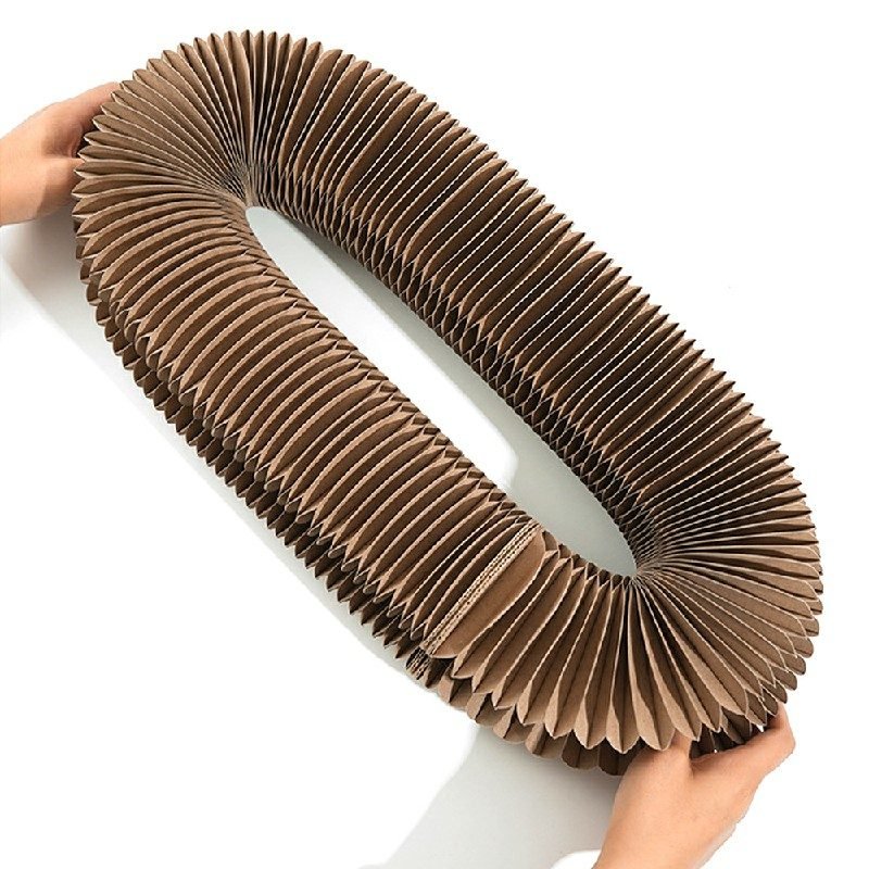 Hands stretching the Magic Organ accordion cat scratcher into a large oval ring, showing its flexible expandable design.